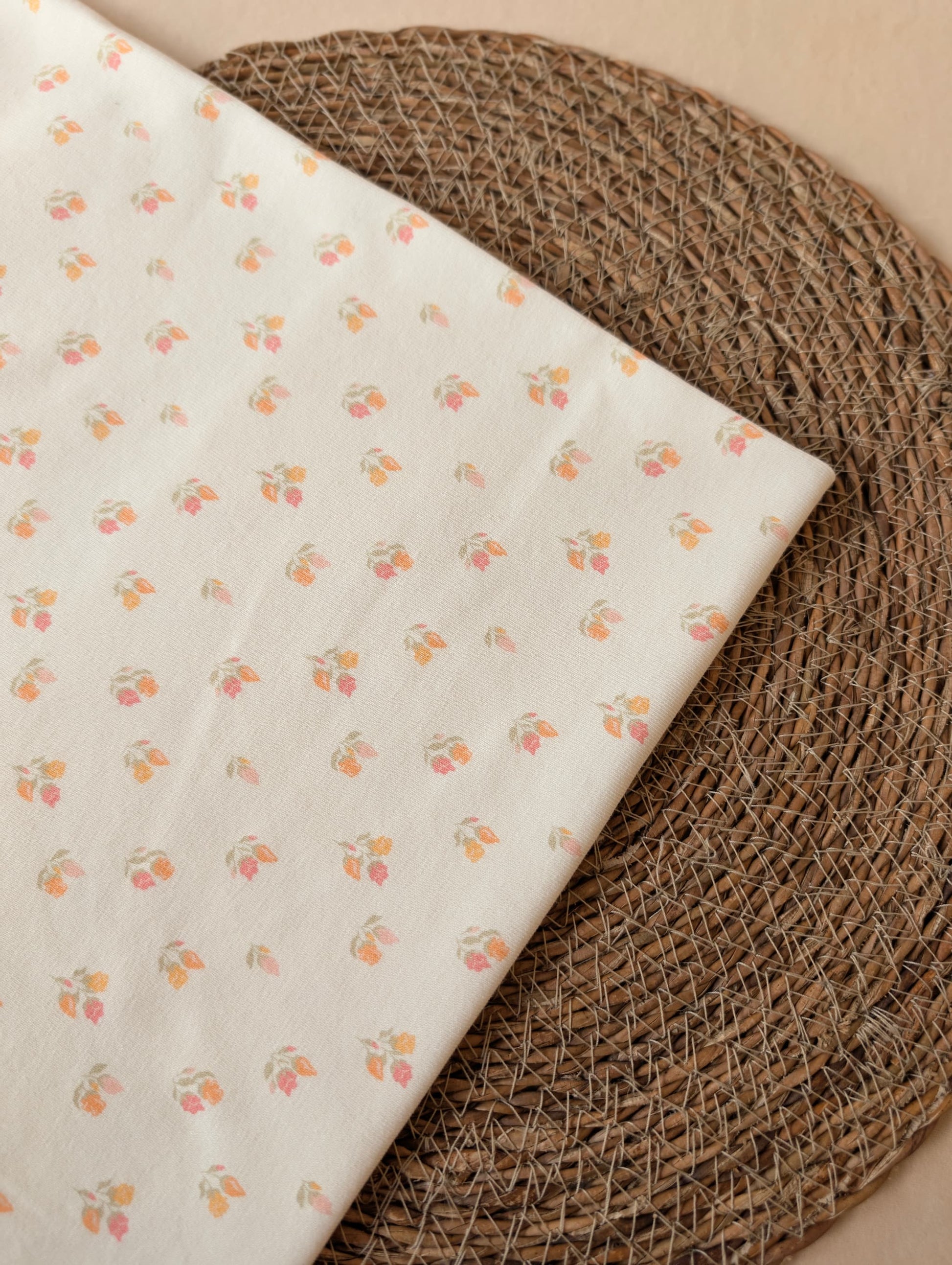 Beatrice Floral Cotton Rib in Pastel folded flat on wicker mat — delicate floral print in soft pastel tones on 1x1 cotton rib jersey — Esorai