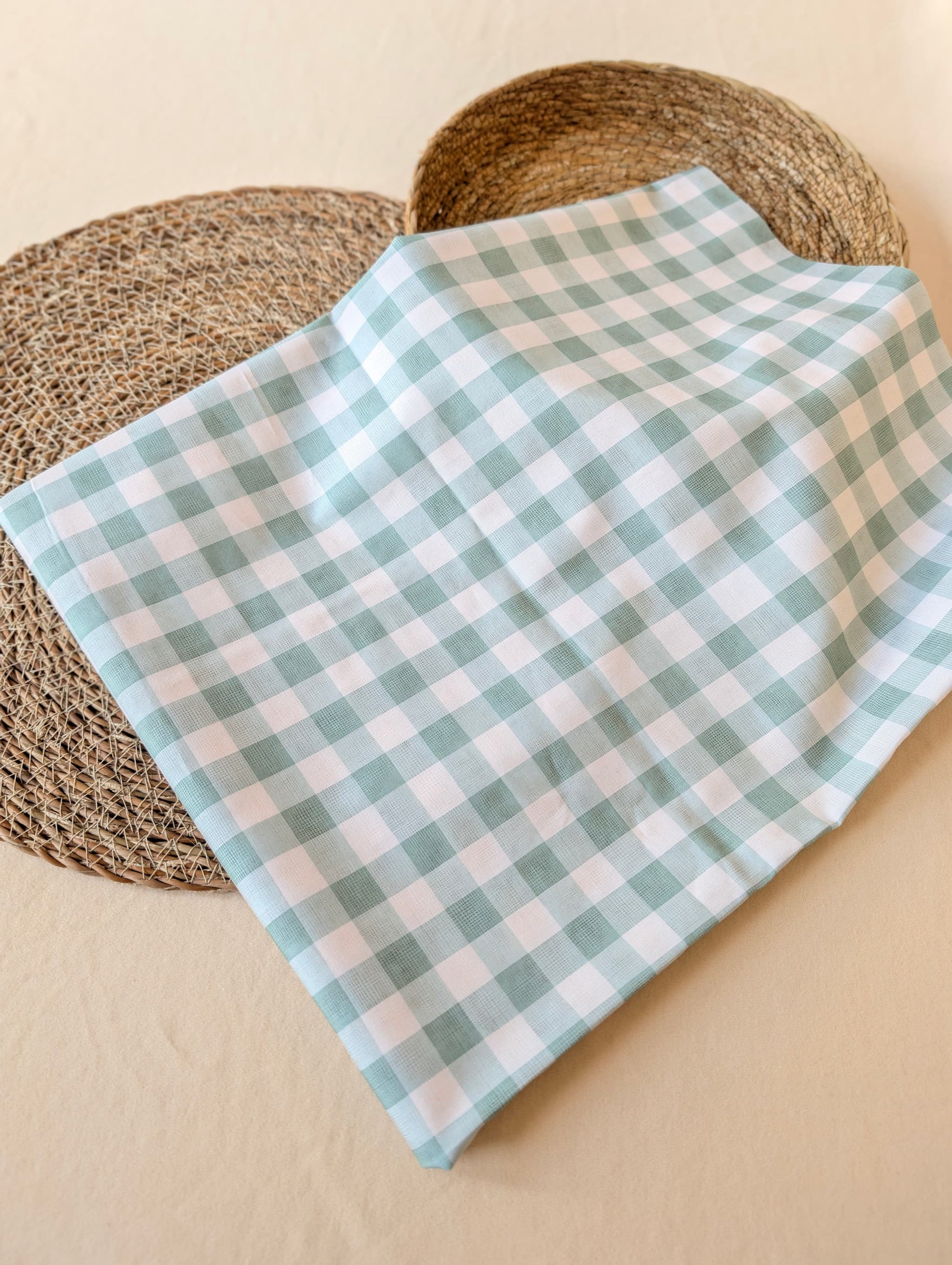 Celeste Sage Gingham Check Cotton — sage green and white gingham fabric draped over a wicker basket