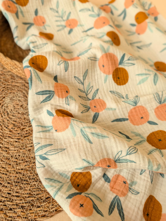 Floral-patterned fabric with orange and pink flowers on a textured surface