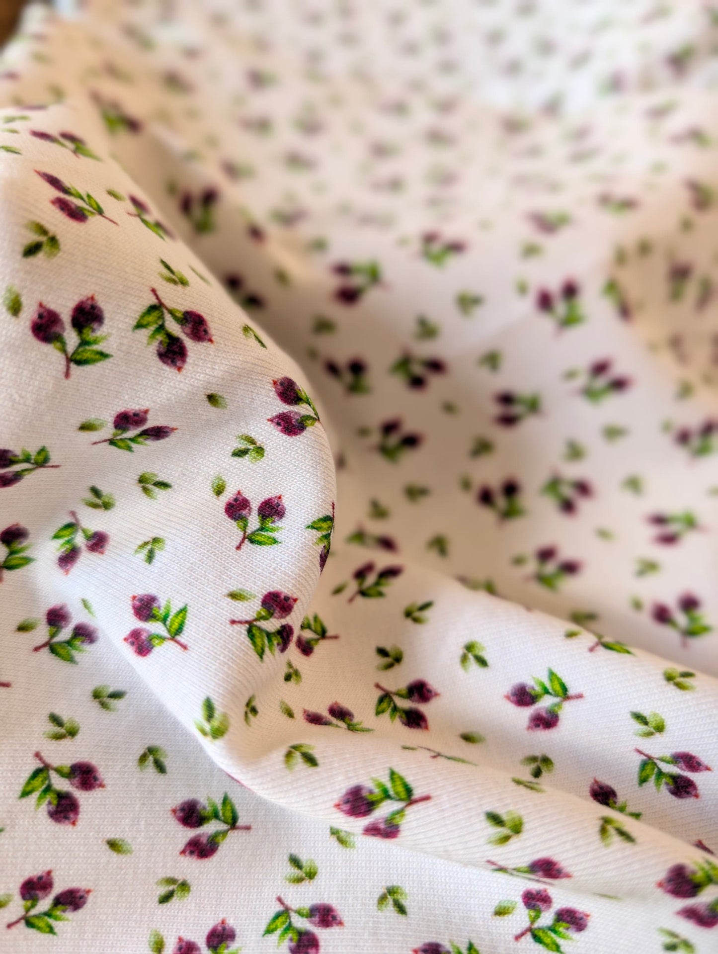 Cotton rib fabric gathered in a rattan basket showing texture and drape — Mini Blueberries ditsy print cotton rib