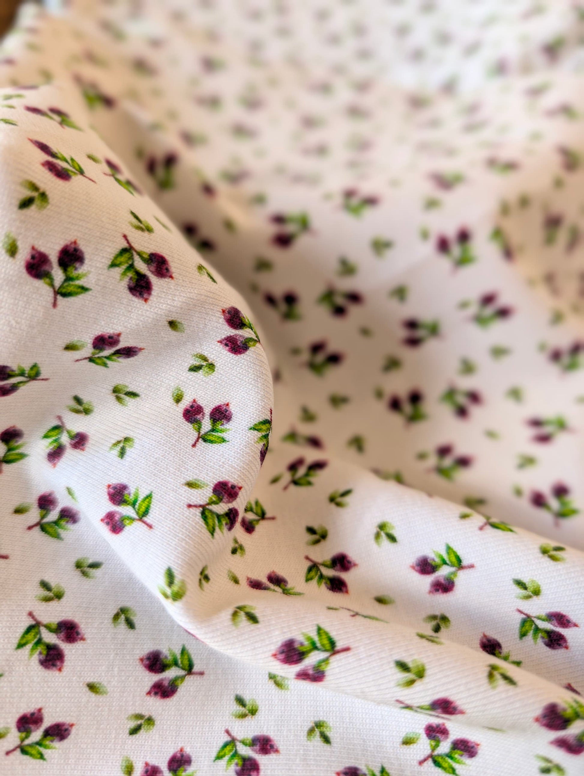Cotton rib fabric gathered in a rattan basket showing texture and drape — Mini Blueberries ditsy print cotton rib