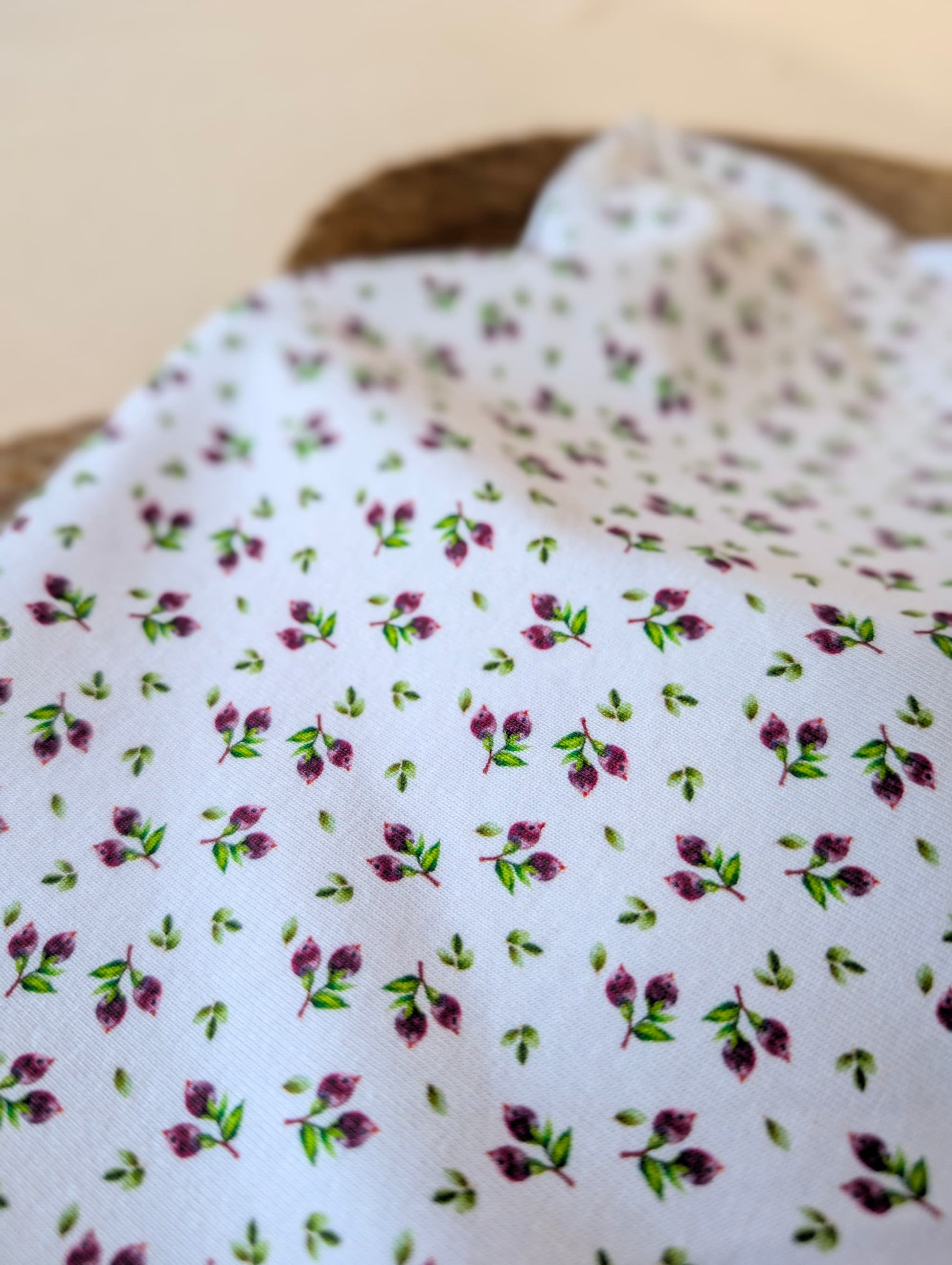 Close-up of cotton rib fabric showing small scattered plum berry and green leaf print — Mini Blueberries on white